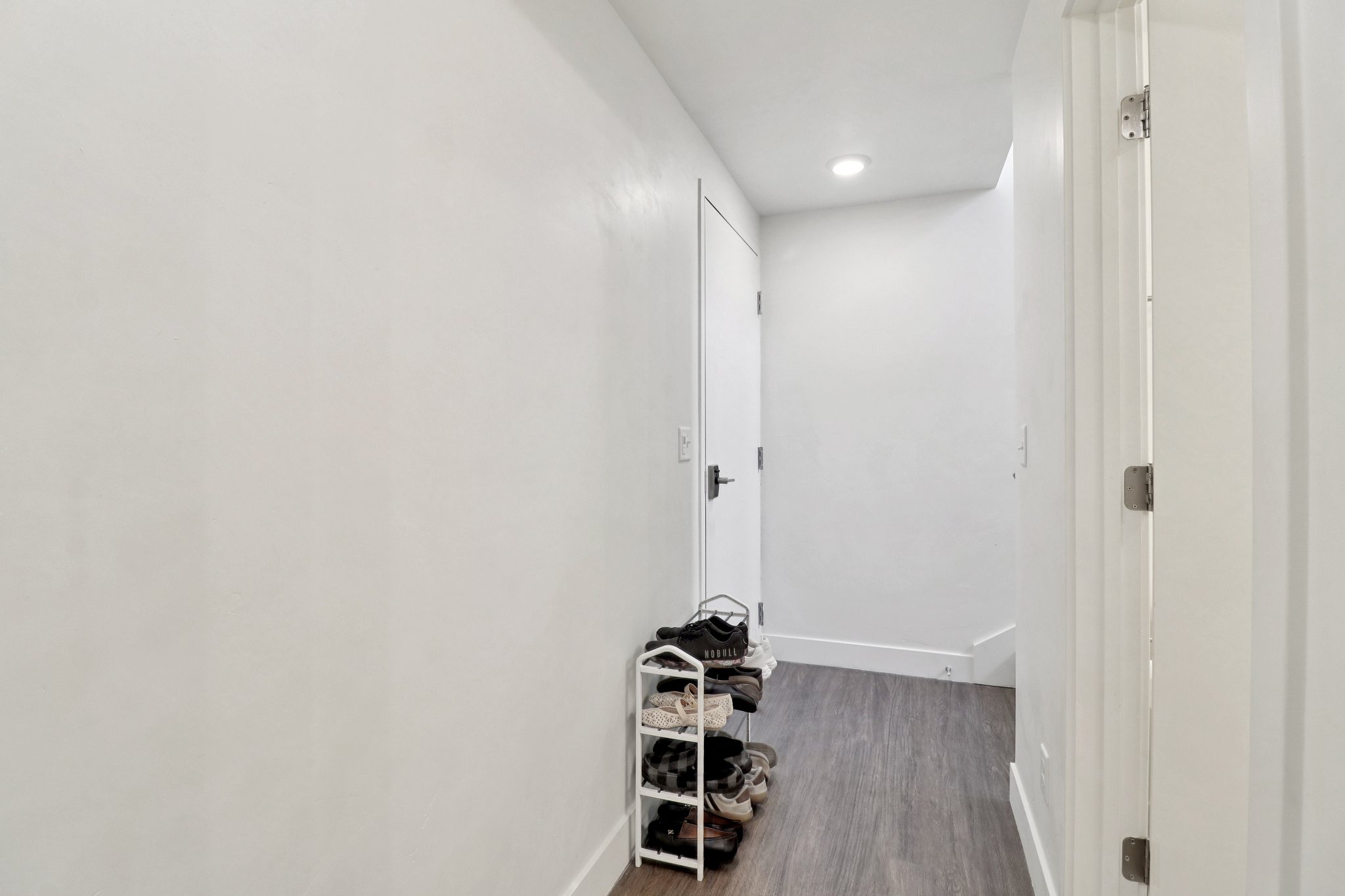 Hall with dark wood-style floors and recessed lighting