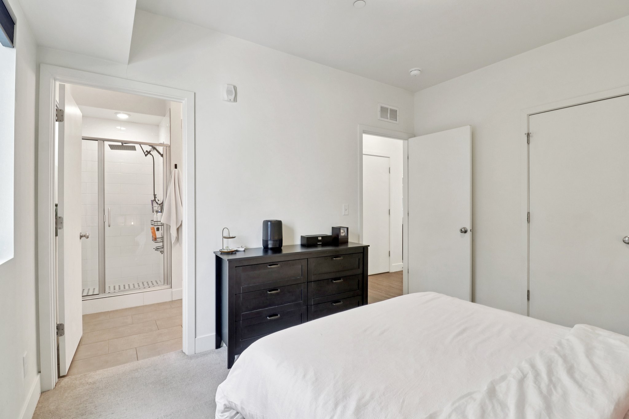 Bedroom with light carpet and a closet