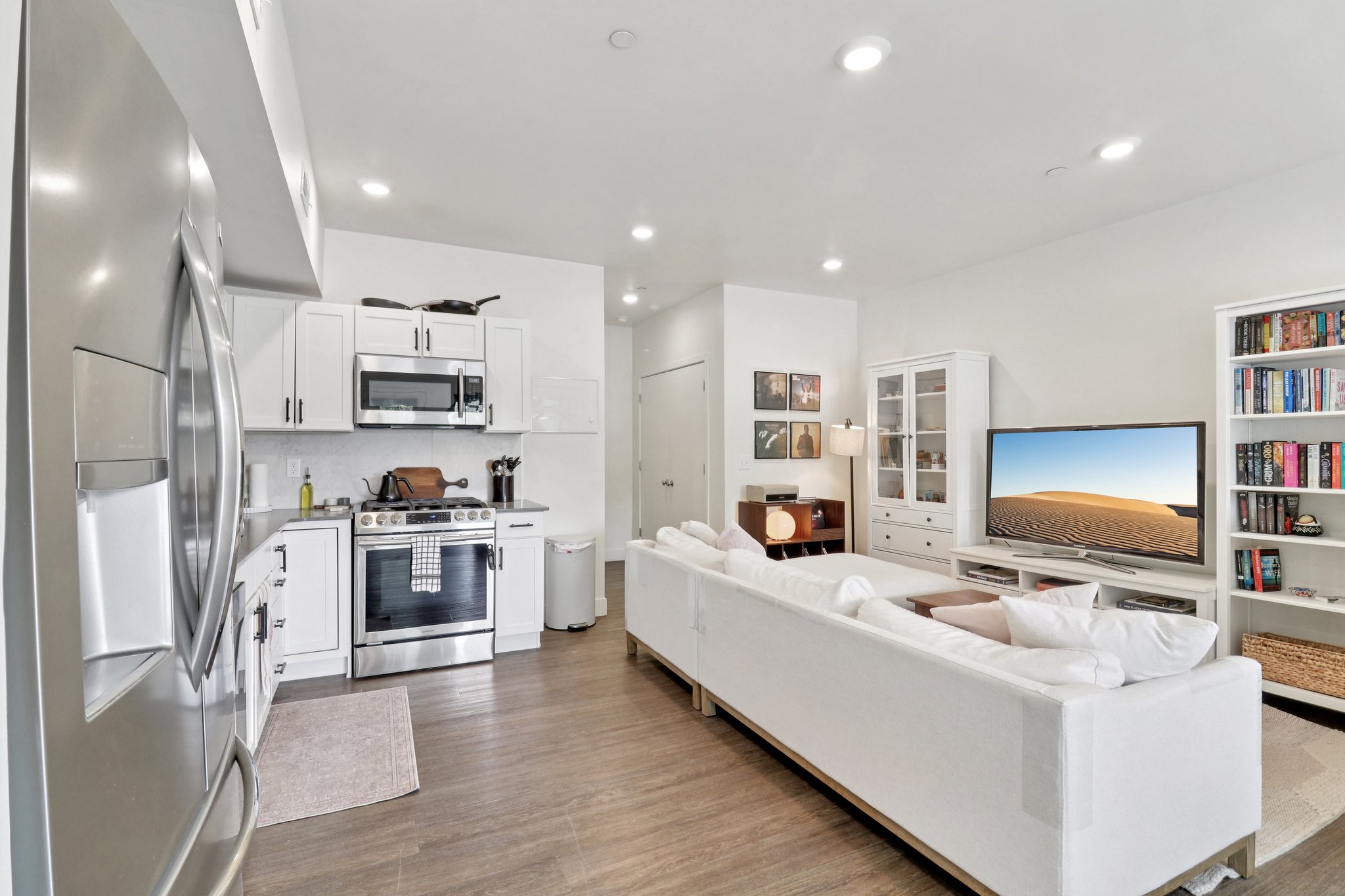 Living room with dark wood-style flooring and recessed lighting