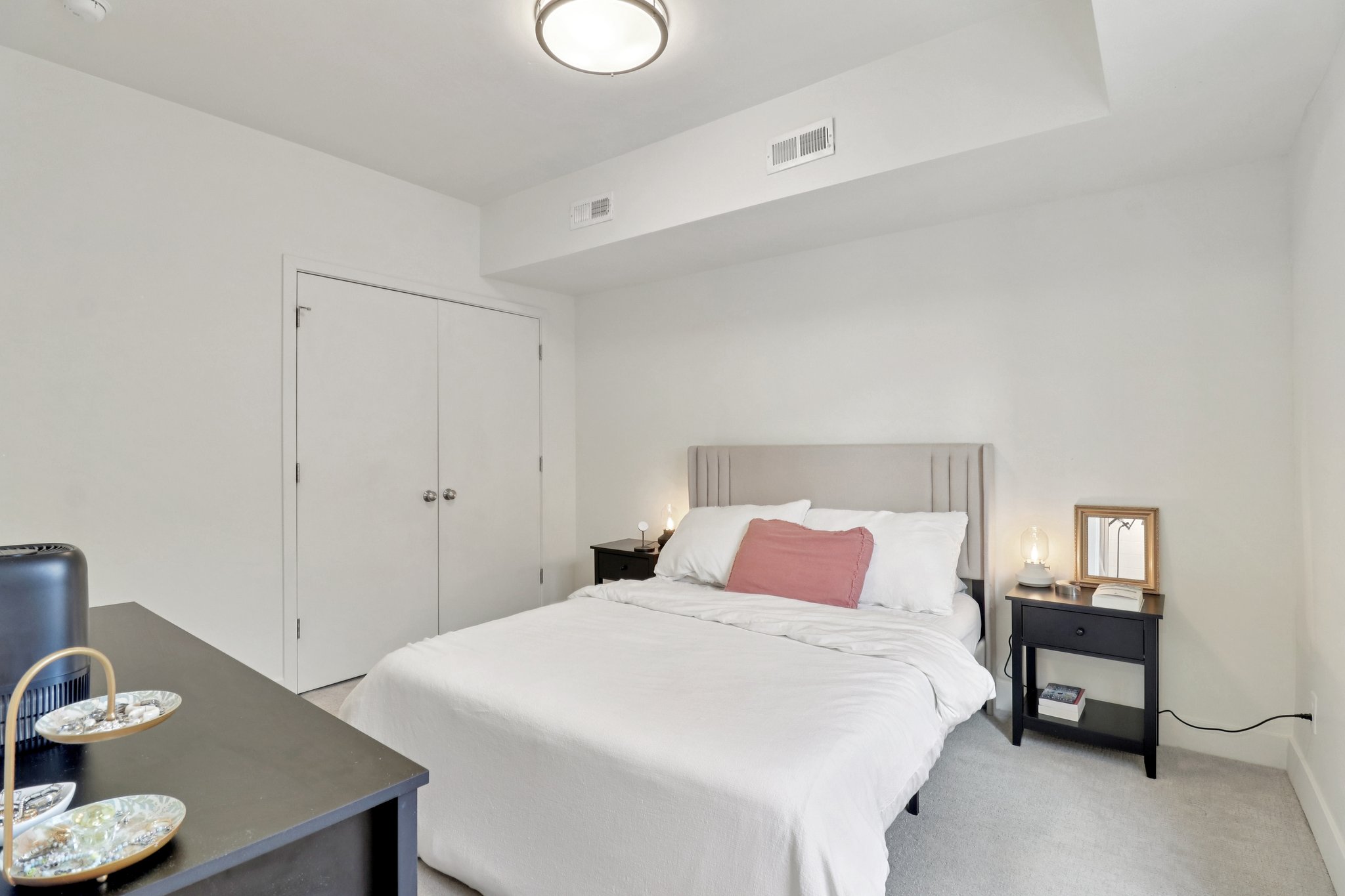 Bedroom featuring light colored carpet and a closet