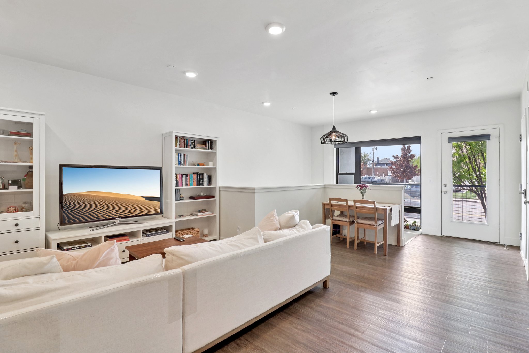 Living room featuring dark wood-type flooring and recessed lighting