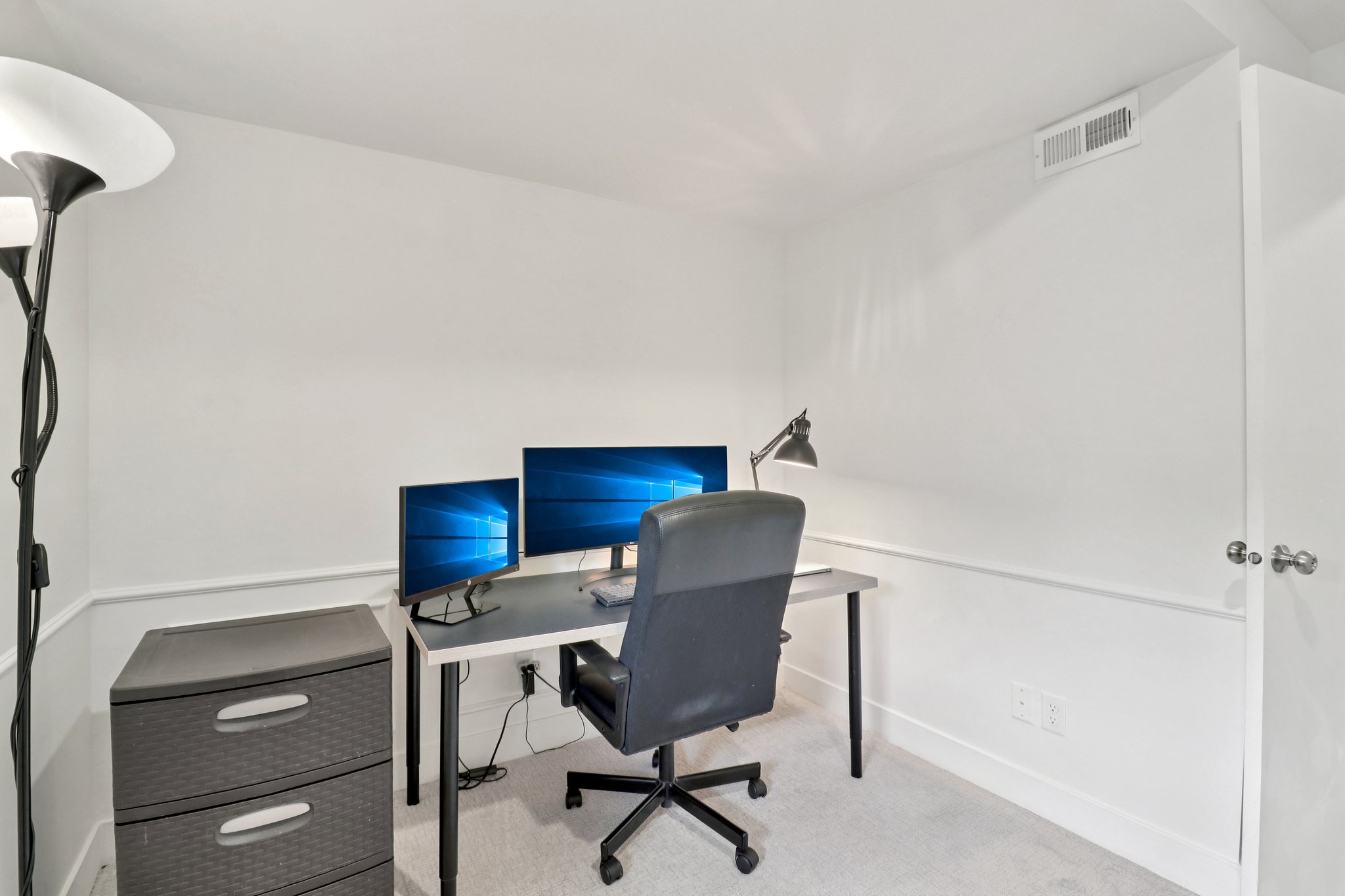 Office space featuring light colored carpet and baseboards