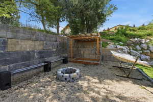 View of yard with an outdoor fire pit