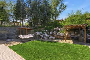 View of yard with a pergola and a patio area