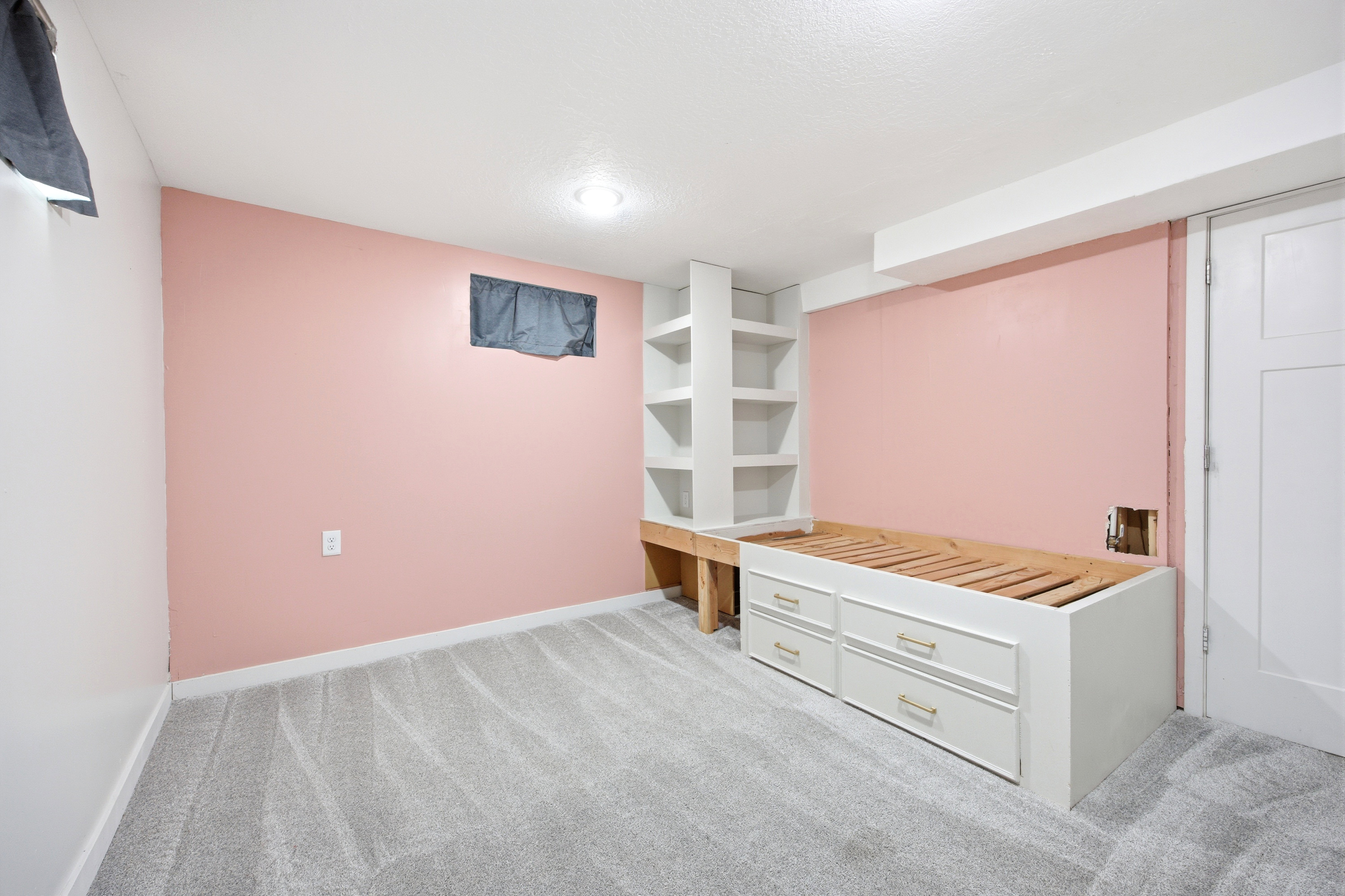 Built-in shelving and platform bed frame with storage drawers