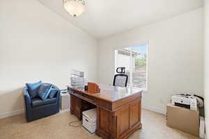 Bright room featuring a window with horizontal blinds, neutral wall paint, and textured carpet flooring