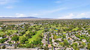 Aerial view of residential area featuring a local golf course and a water and mountain view