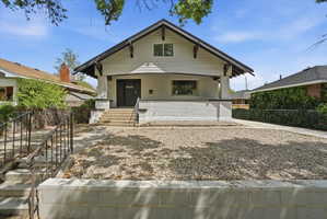 View of front facade featuring a porch and brick siding