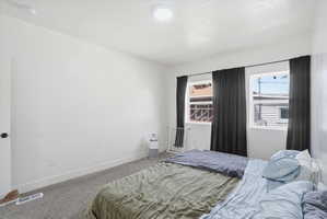 Bedroom featuring carpet floors and a textured ceiling