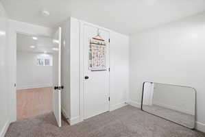 Bedroom featuring a textured ceiling, light colored carpet, and recessed lighting