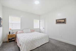 Carpeted bedroom with baseboards