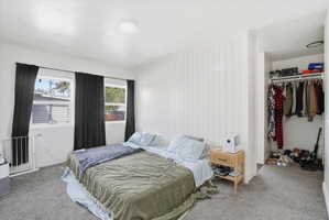 Bedroom featuring a closet, carpet floors, and a textured ceiling