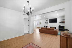 Living room featuring a textured ceiling, a fireplace, and hanging lights