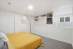 Bedroom featuring carpet floors and baseboards