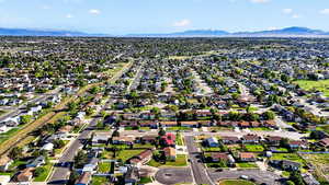 Aerial perspective of suburban area featuring a mountain backdrop