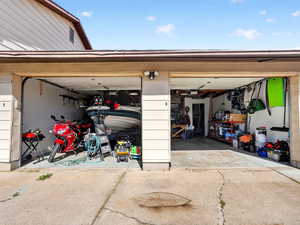 Garage featuring concrete driveway