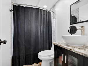 Bathroom with vanity and curtained shower
