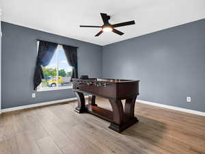 Game room featuring light wood-style flooring and ceiling fan