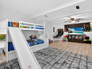 Bedroom with light wood finished floors and a ceiling fan