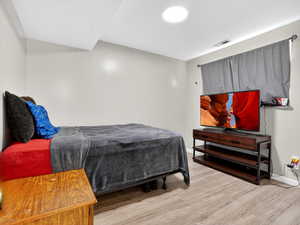 Bedroom featuring light wood-style flooring and baseboards