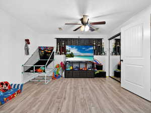 Playroom featuring light wood finished floors and ceiling fan