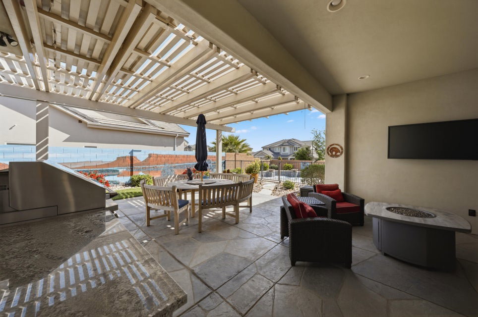 View of patio with an outdoor living / dining area, a pergola, a grill, and an outdoor fire pit