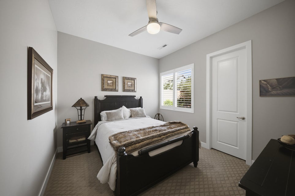 Bedroom with carpet and a ceiling fan