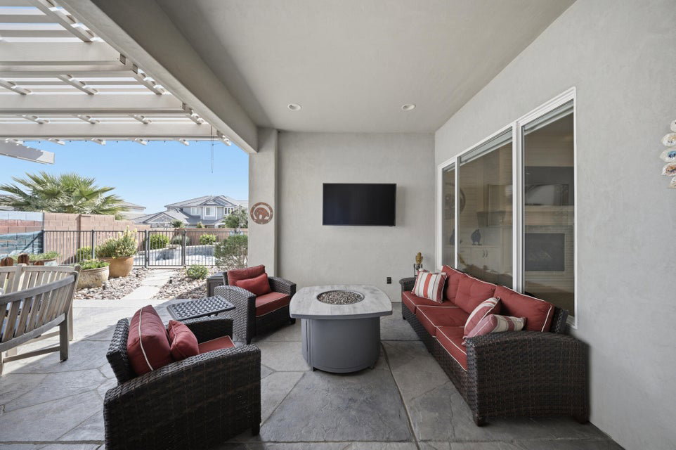 View of patio with an outdoor living space with a fire pit and a pergola
