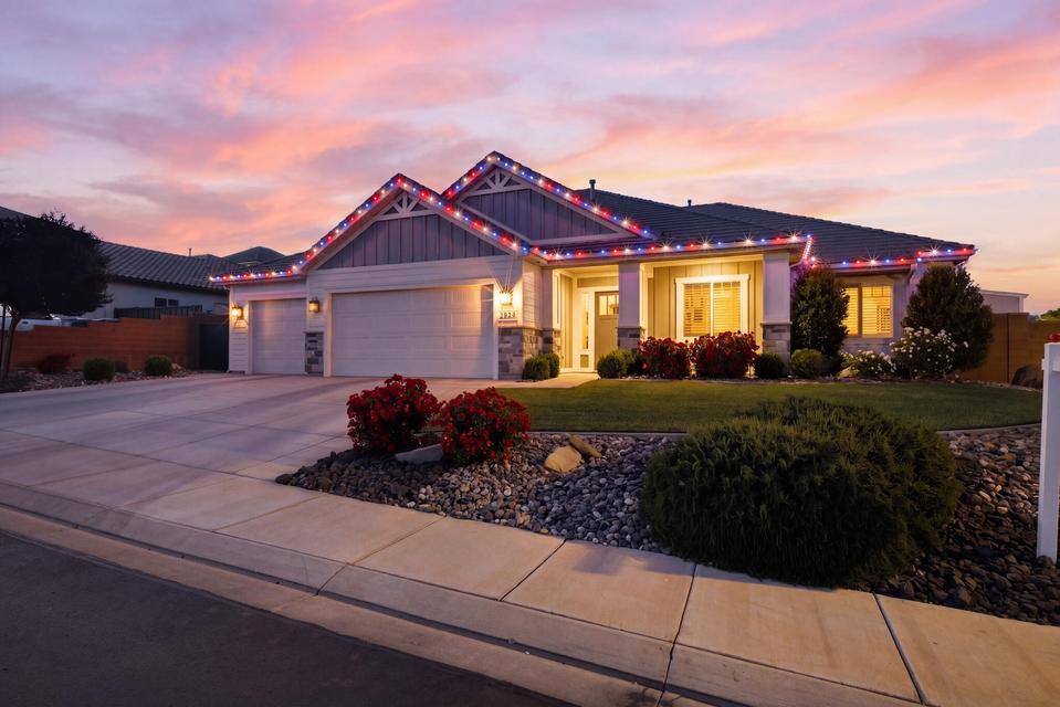 Craftsman inspired home with a garage, driveway, and board and batten siding