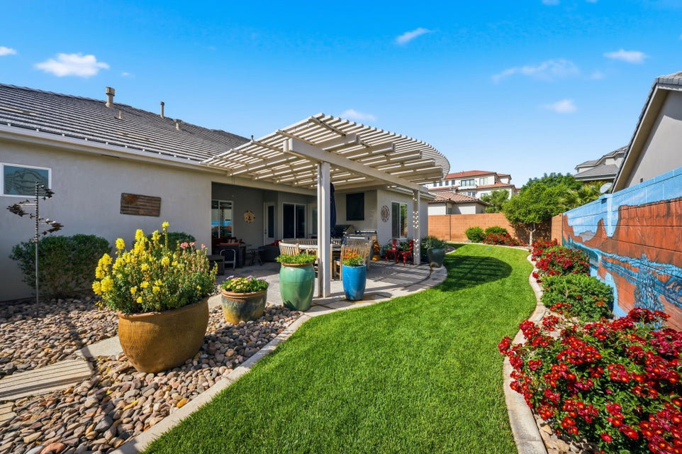 Back of house with a patio, a pergola, stucco siding, and a fenced backyard
