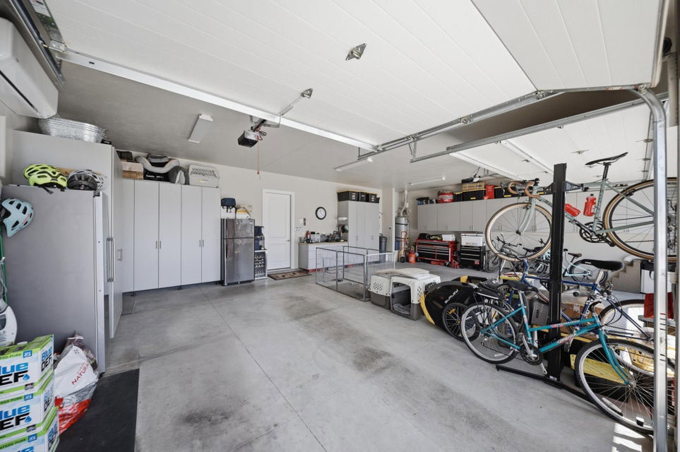 Garage with freestanding refrigerator and a mini split for heating / cooling