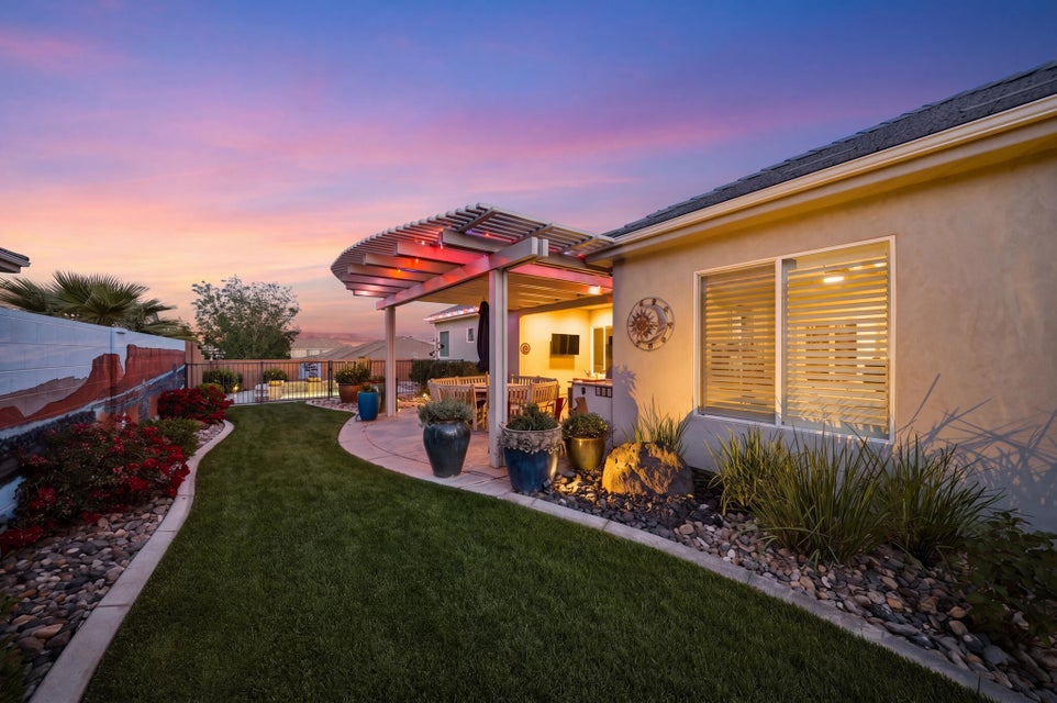 Fenced backyard with a patio and a pergola