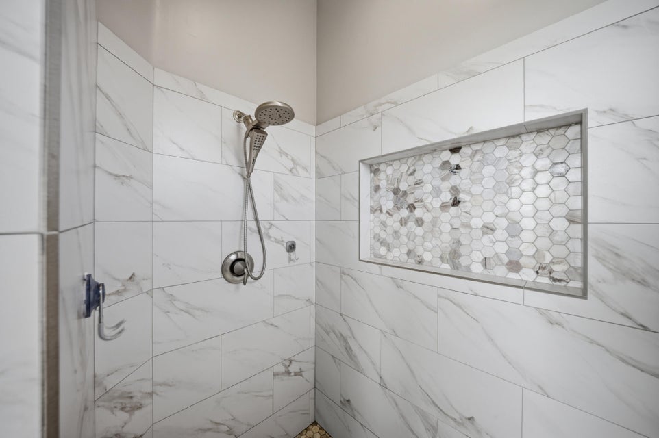 Full bath with a tile shower