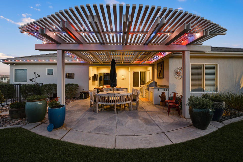 View of patio featuring a pergola and an outdoor kitchen / dining area
