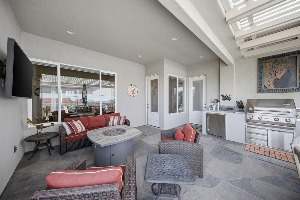 View of patio / terrace with an outdoor fire pit and an outdoor kitchen with living area