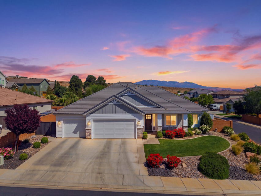 Craftsman-style home with a garage, stone siding, concrete driveway, board and batten siding, and a residential view