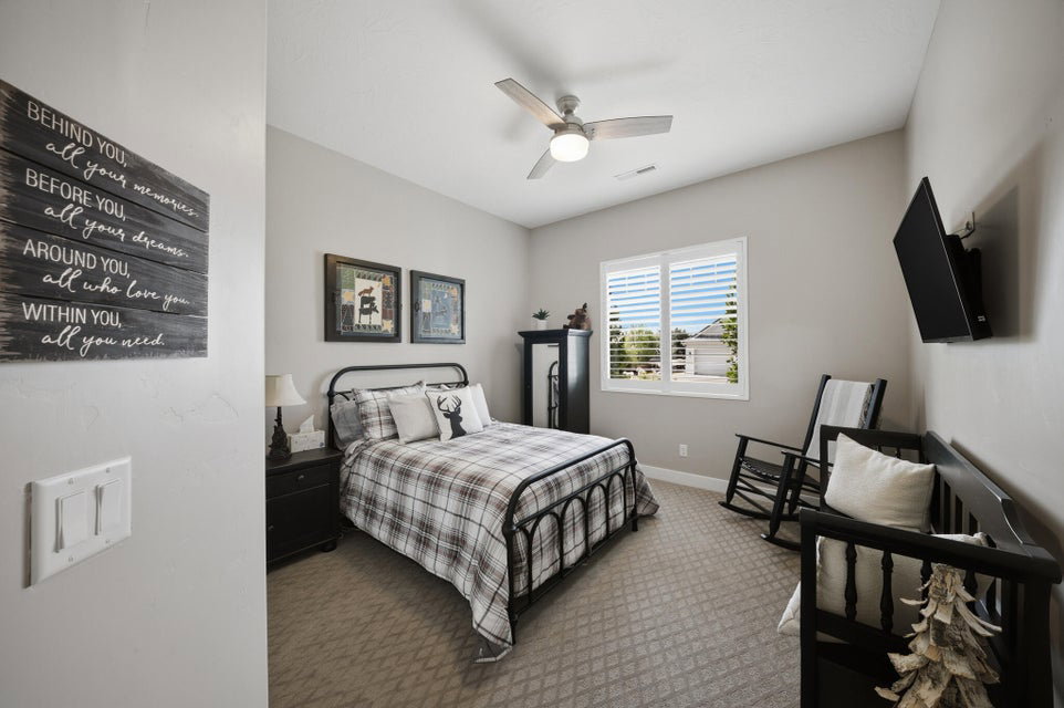 Bedroom with carpet and ceiling fan