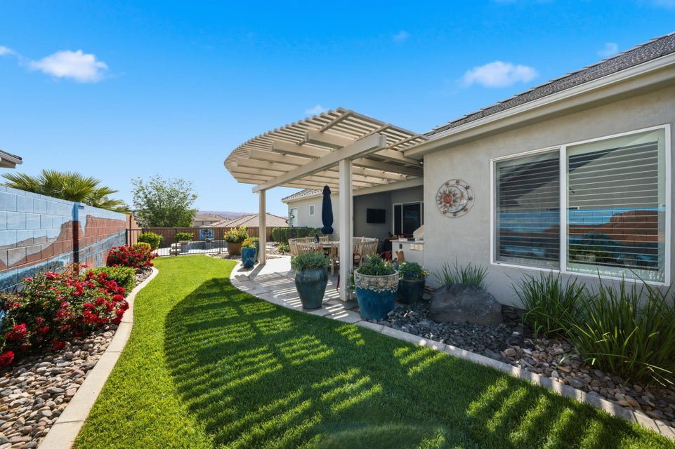Fenced backyard featuring a pergola and a patio area