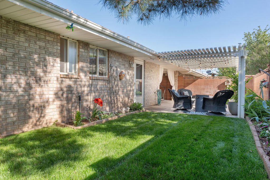 Fenced backyard with a patio area and a pergola