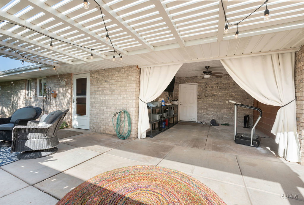 View of patio / terrace featuring a ceiling fan and a pergola