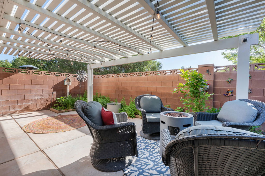 Fenced backyard featuring a pergola, a fire pit, and a patio area