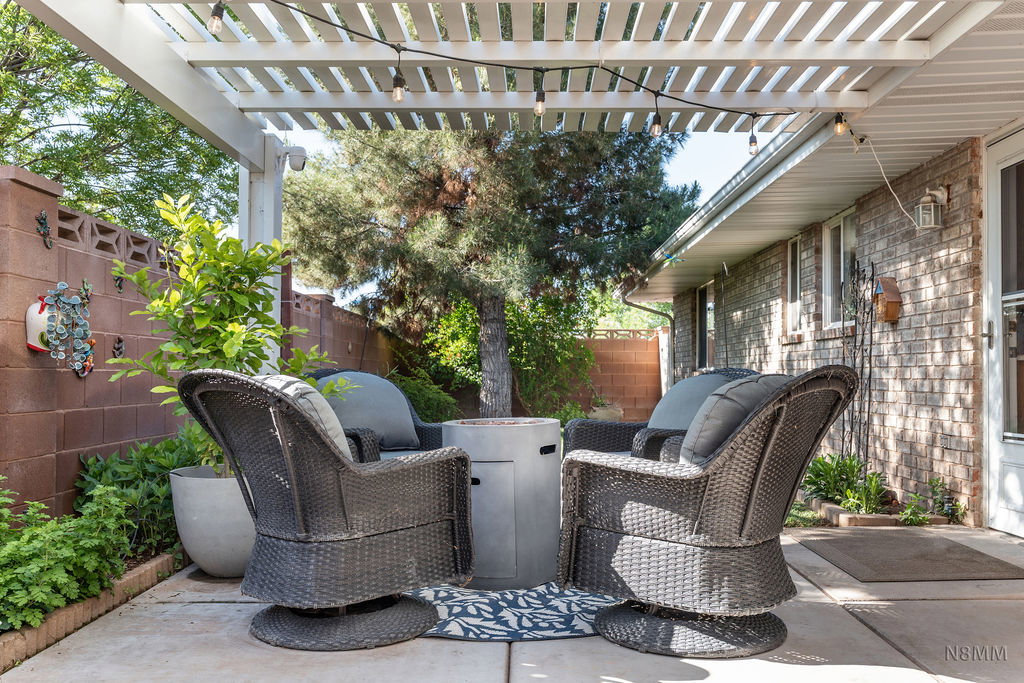Fenced backyard with a pergola and a patio