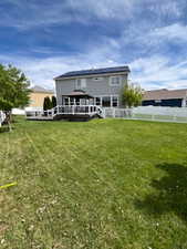 Rear view of house featuring a deck