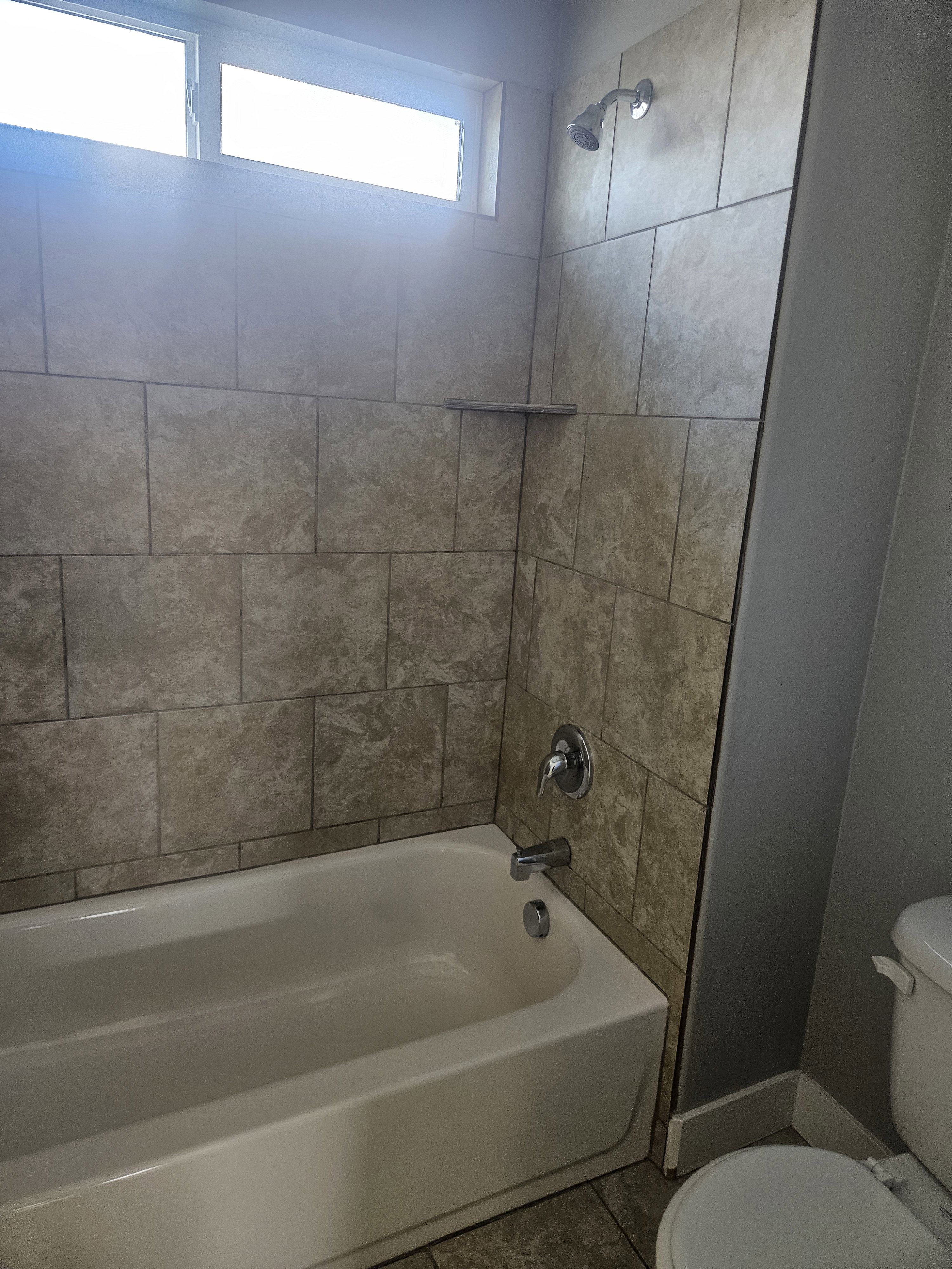 Bathroom with shower / bath combination and tile patterned floors