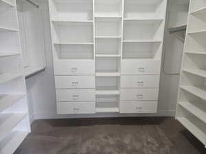 Walk in closet featuring dark carpet