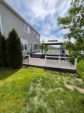 View of grassy yard with a deck and a gazebo