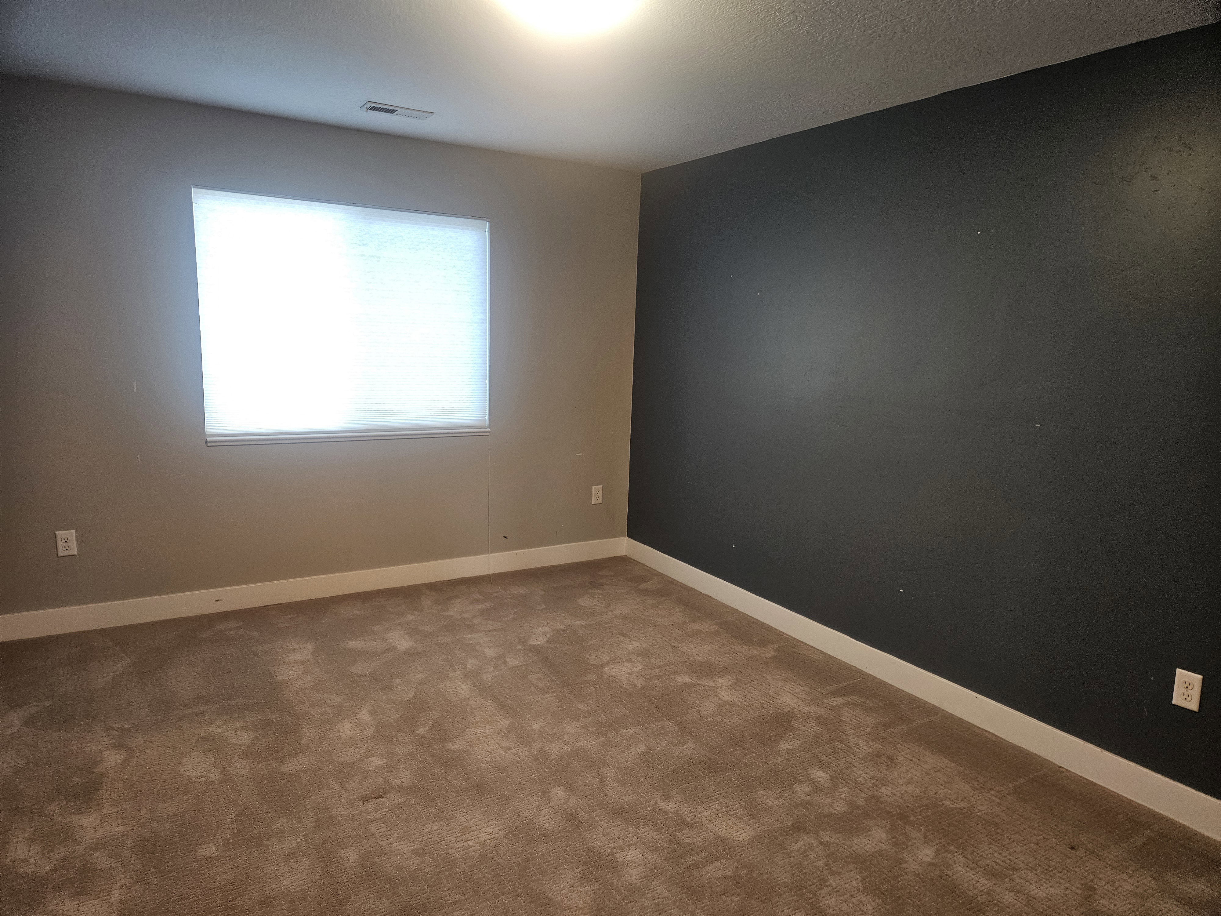 Spare room with baseboards and carpet floors