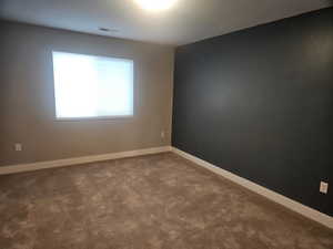 Spare room with baseboards and carpet floors
