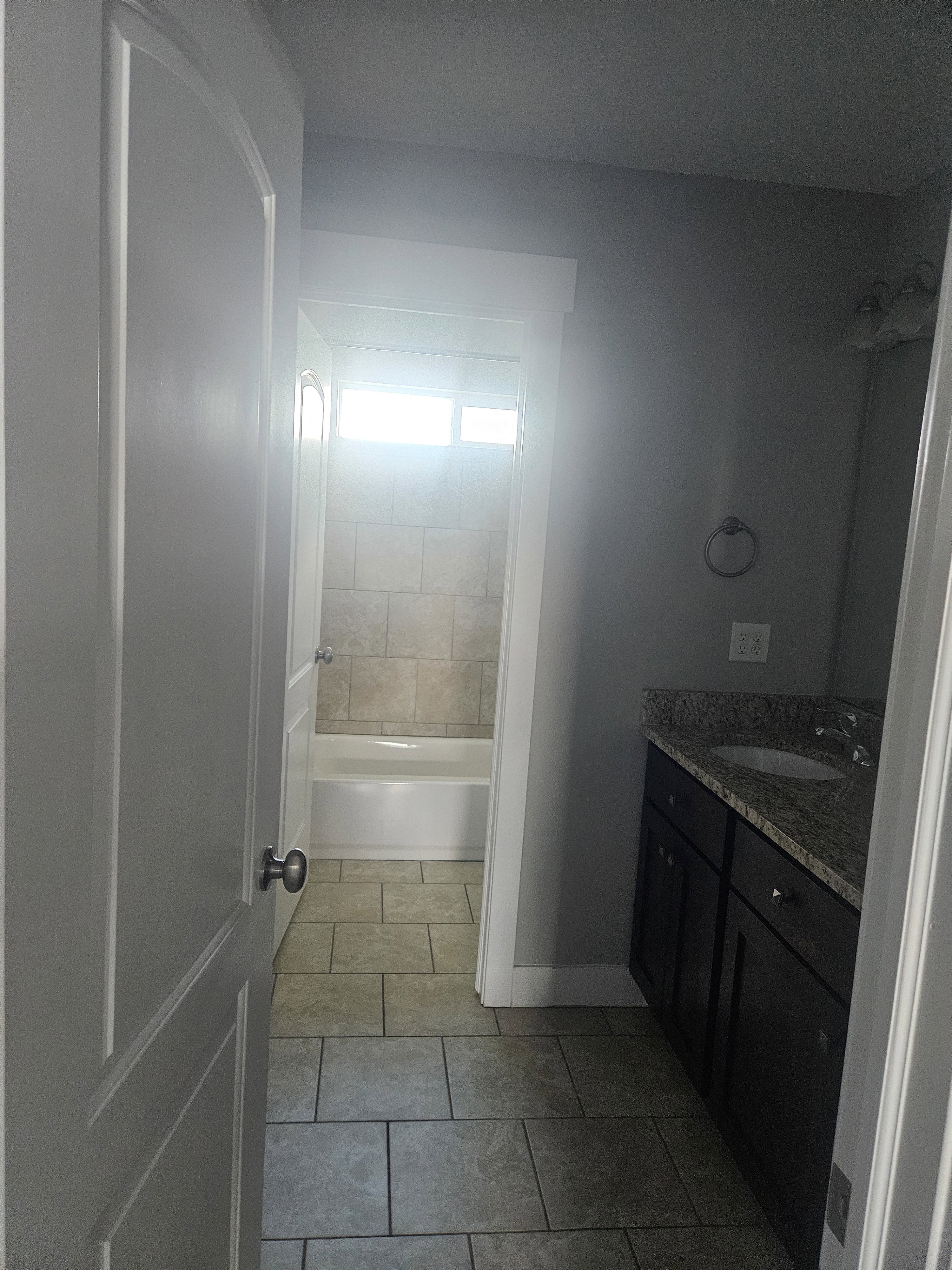 Bathroom with vanity, light tile patterned flooring, and  shower combination