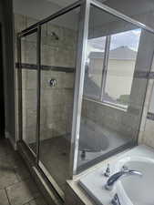 Full bathroom featuring a stall shower and a bath